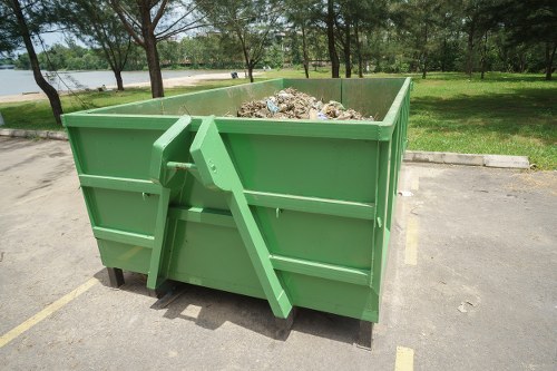 Skip hire process with waste being loaded into a skip